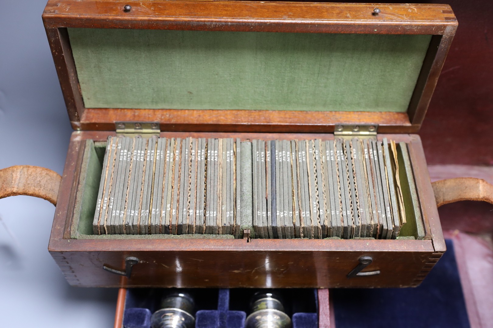 Three cased communion sets together with a mahogany box of slides